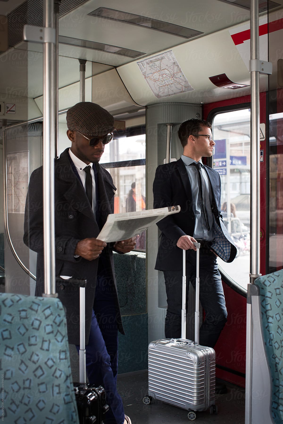 Two Young Business Travelers Commuting in Urban Train