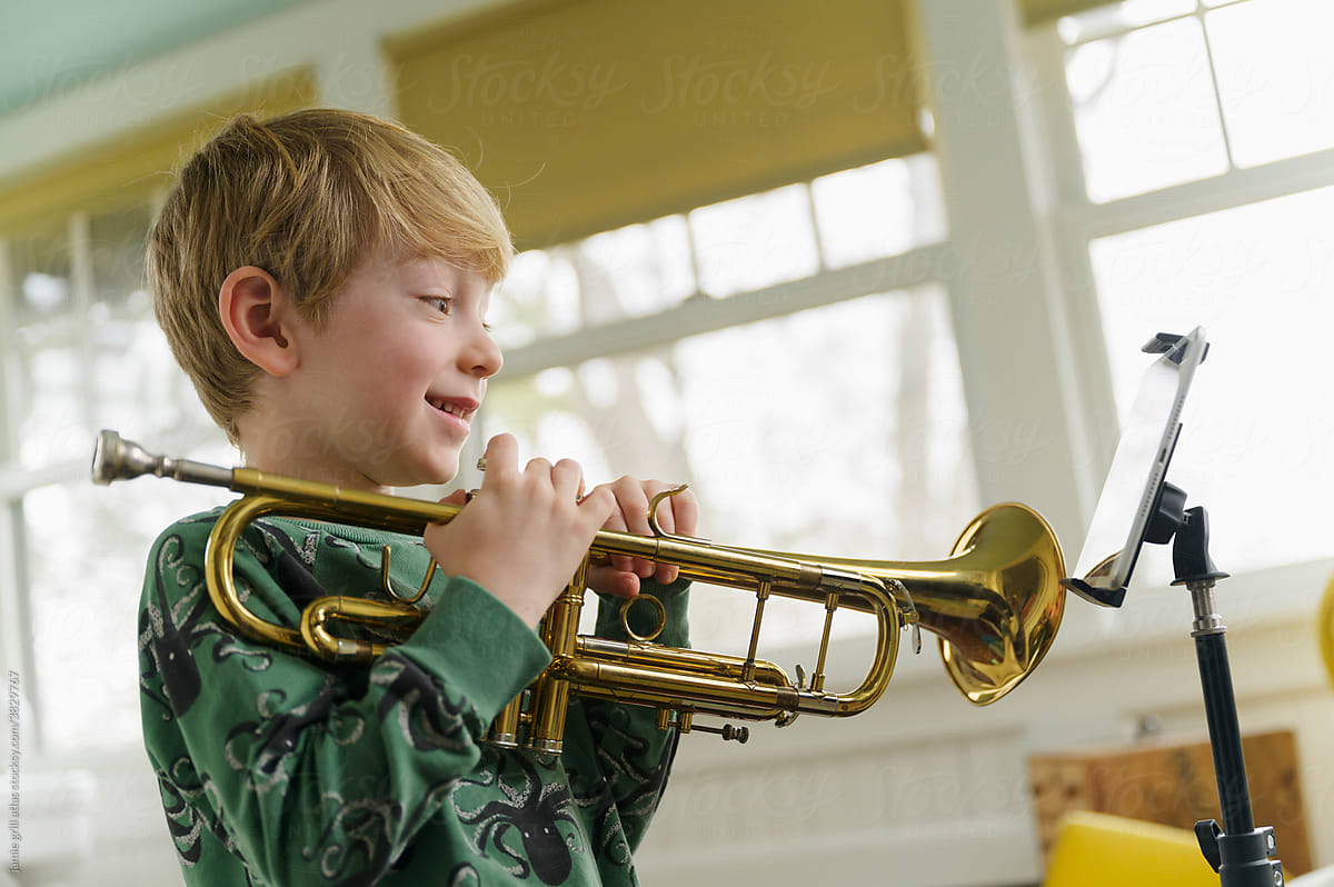 Boy at Virtual Trumpet Lesson with Tablet on Stand