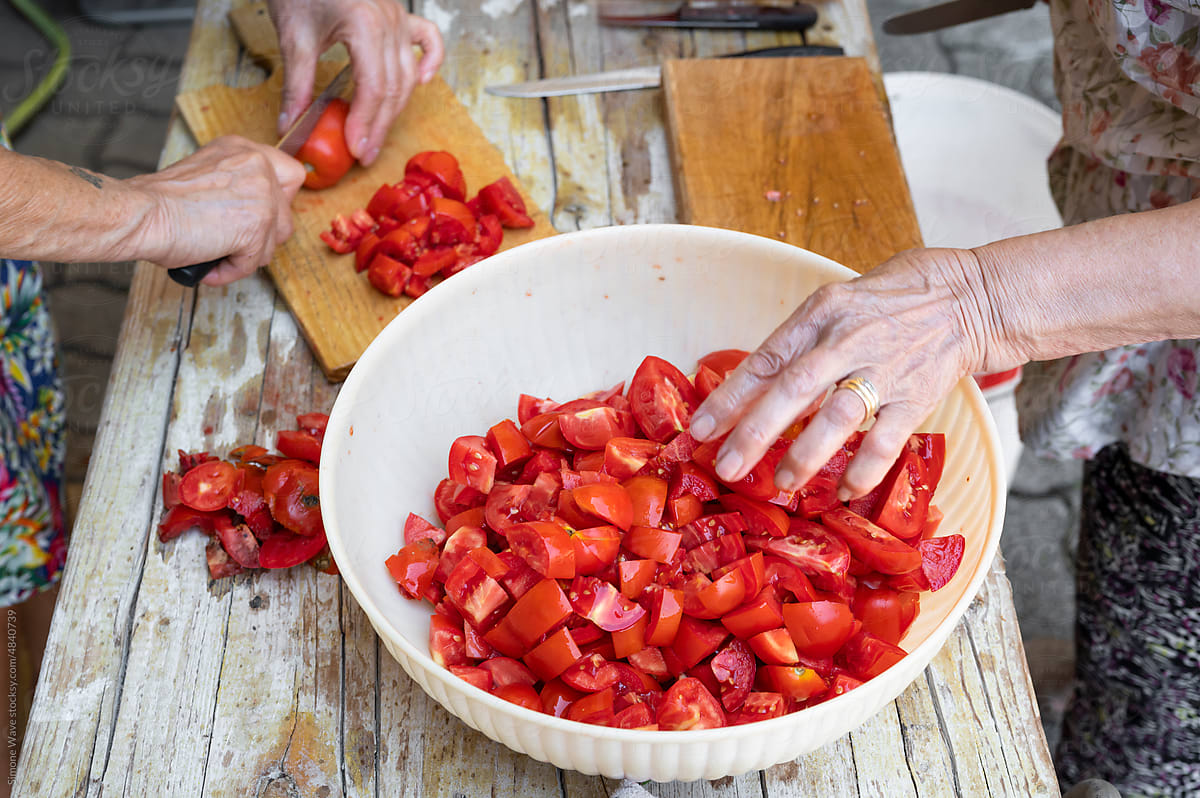 Cleaning and cutting tomatoes for making handmade sauce