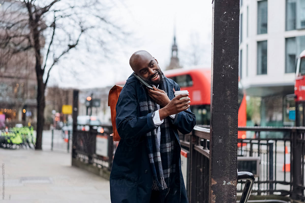 Black Man Smiling and Chatting On the Telephone