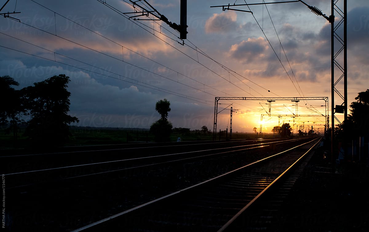 Rail track with sunrays reflected on rail line