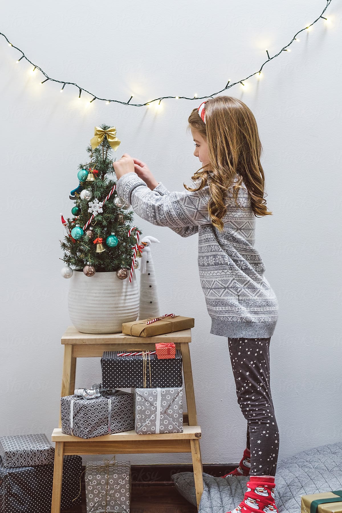 Cute Little Girl Decorating Christmas Tree