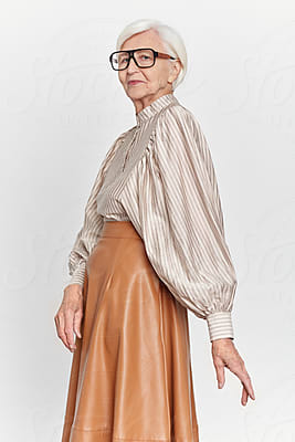 Elderly Woman Wearing Extravagant Clothes, by Stocksy Contributor