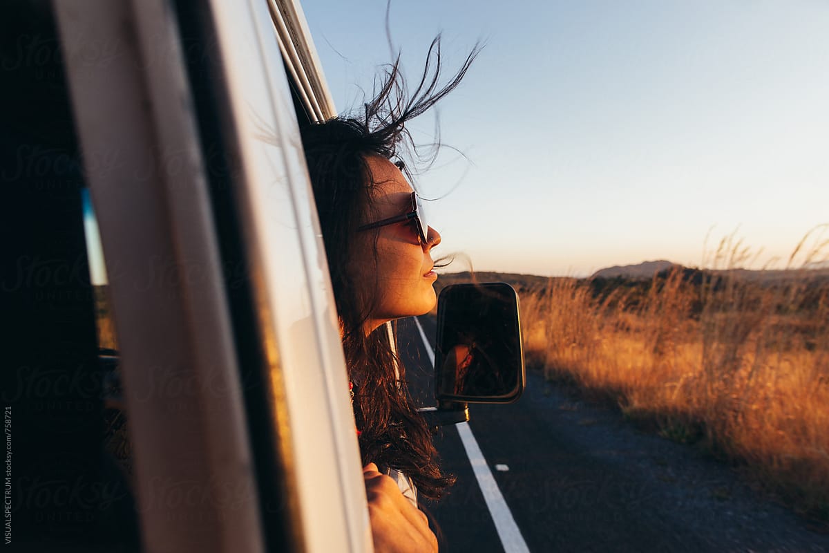 Road Tripping - Beautiful Woman Sticking Head Outside Car Window While Driving