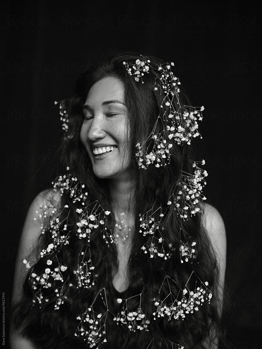 Black and white portrait of an Asian woman with flowers in her hair