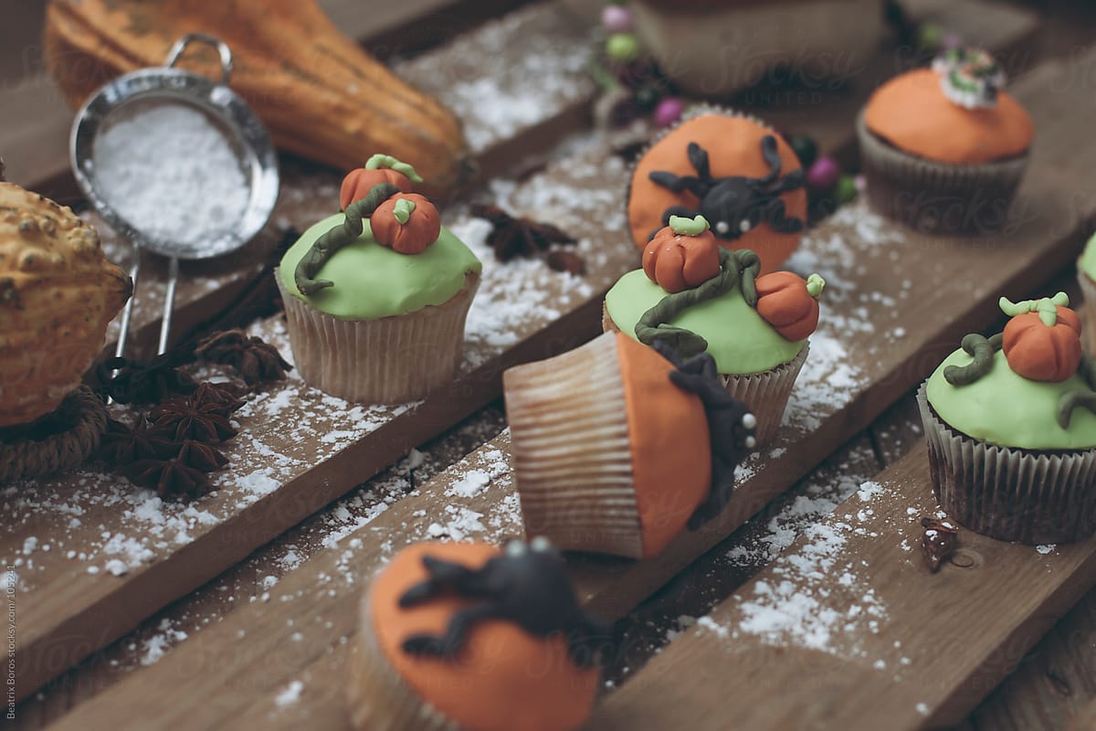 Halloween theme decorated cupcakes with powdered sugar on a table