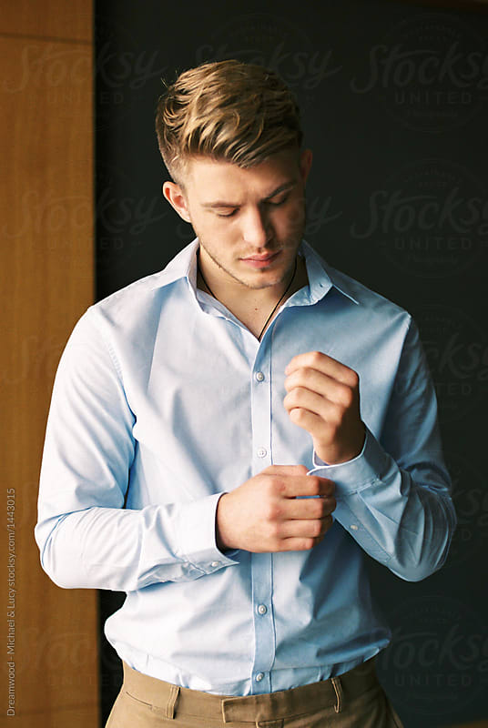 Elegant man buttoning sleeves