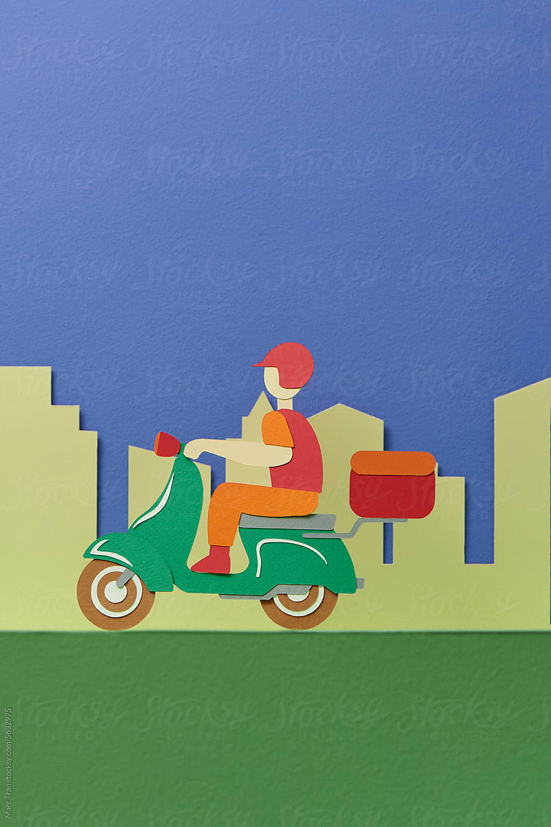 Delivery man wearing uniform riding motorcycle and delivery box.