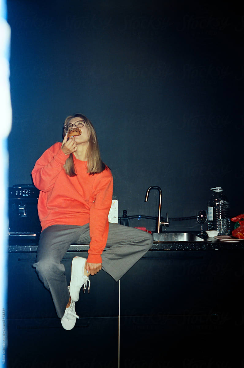 Young woman sitting on office kitchen