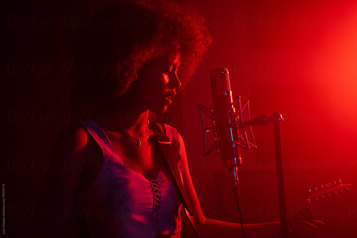 Black Girl Singing And Playing The Guitar In The Studio