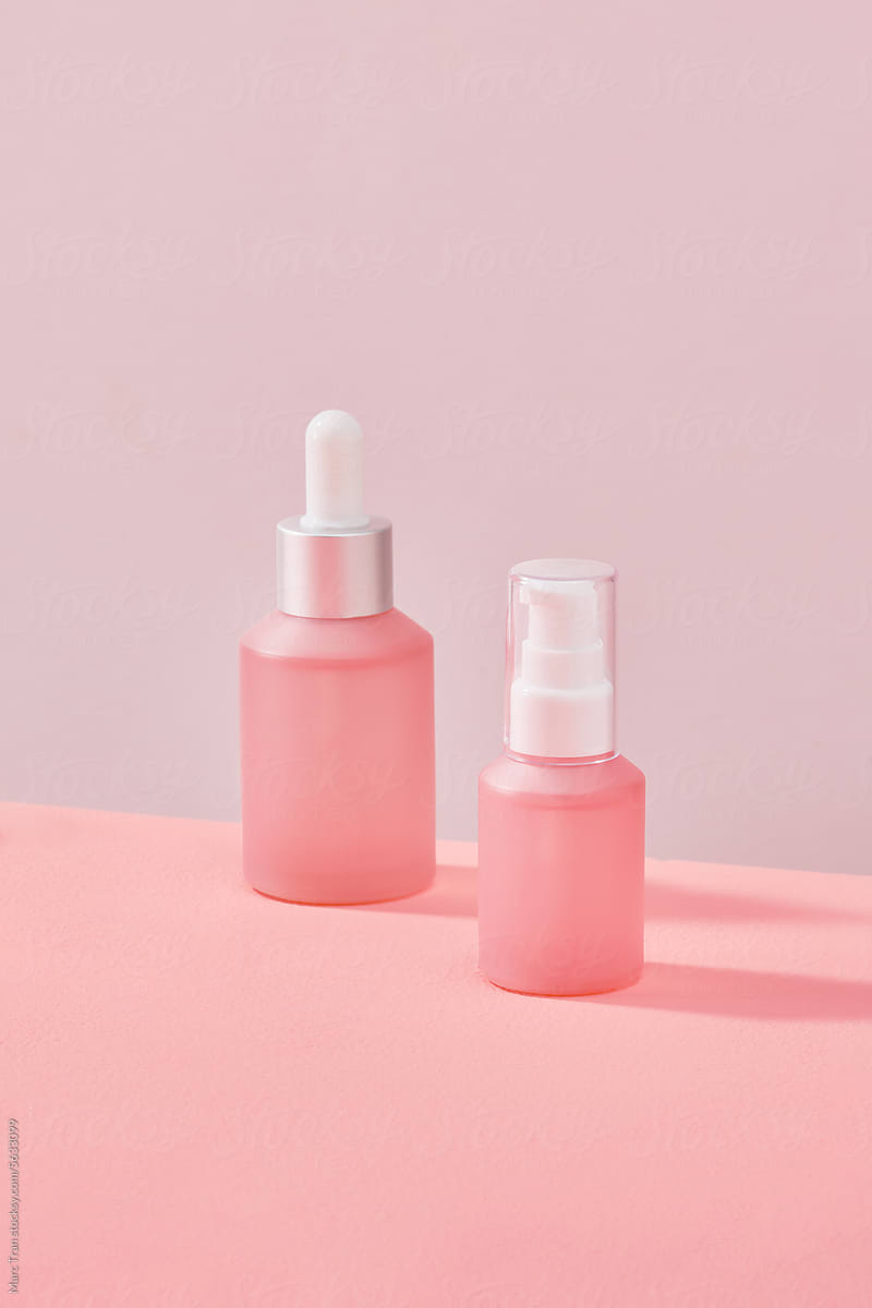 Anti-cellulite massage oil on pink background