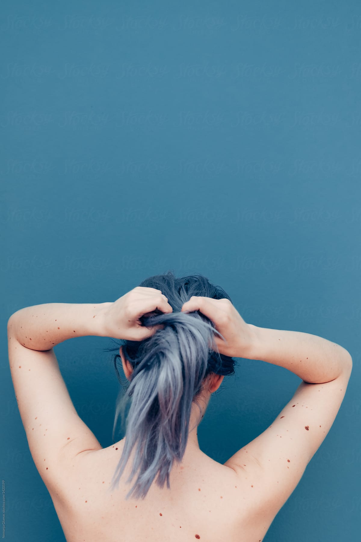 Delicate Young Woman With Pale Skin and Blue Dyed Hair