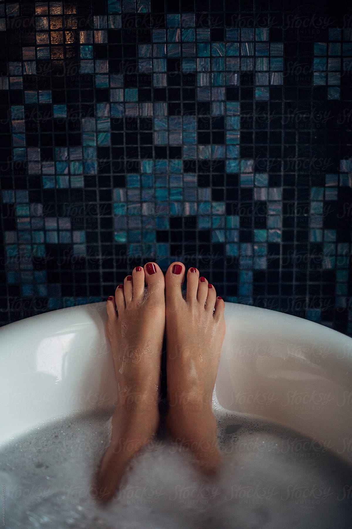 Feet of a Woman Relaxing in the Bathtub