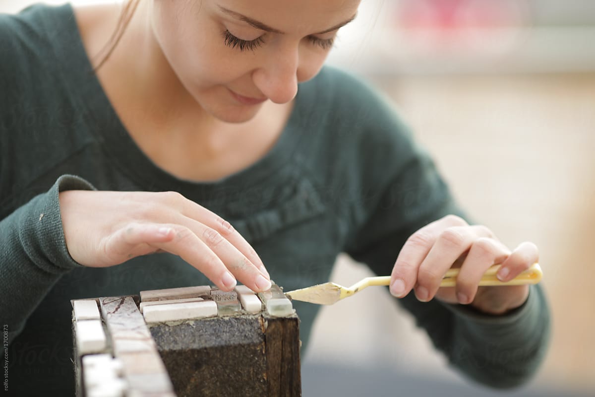 Woman crafting mosaic in workshop