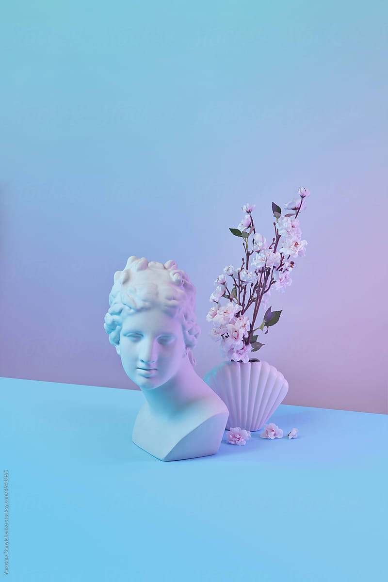 Greek statue and shell vase with spring blooms.