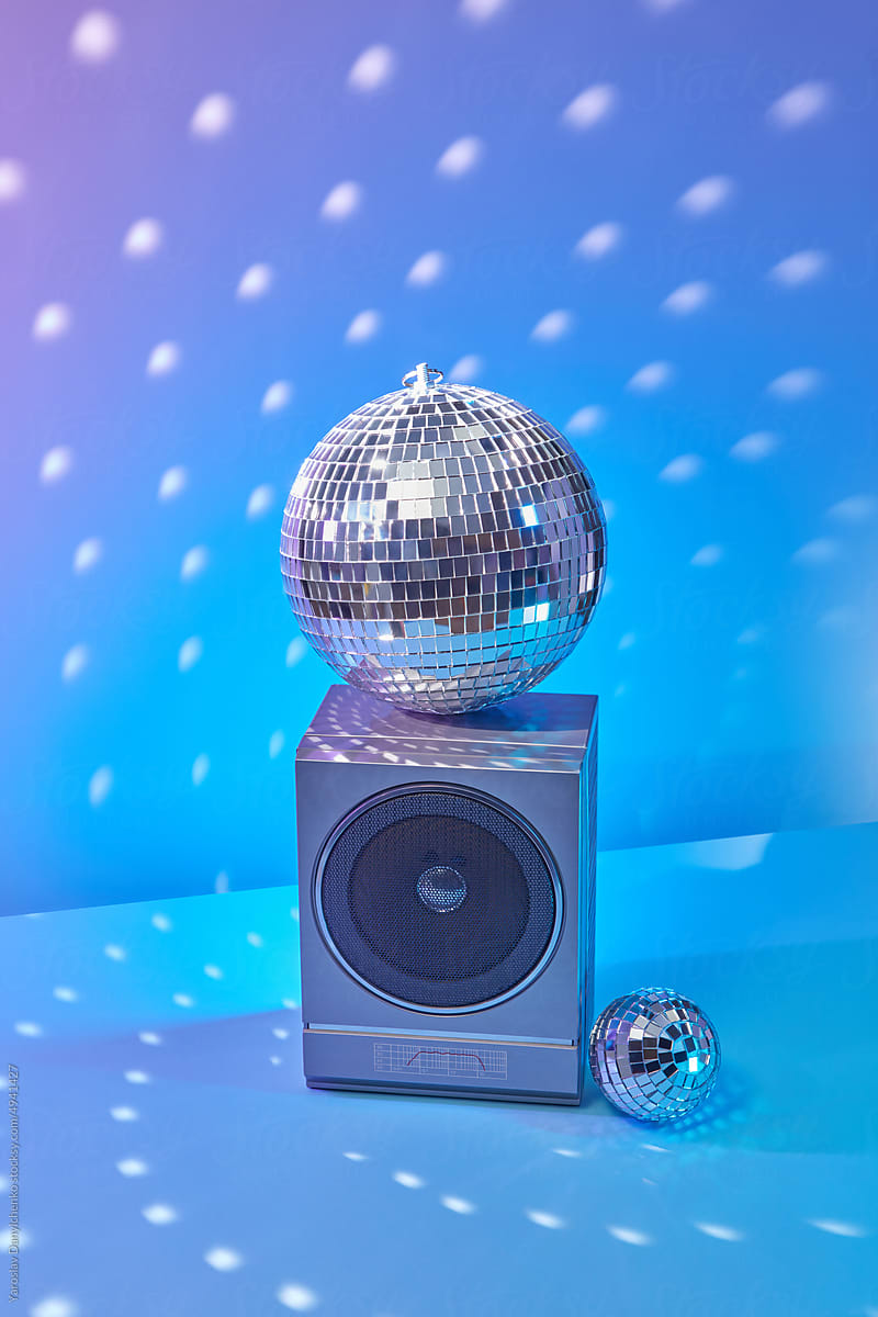 Shiny disco sphere on 90s style loudspeaker.
