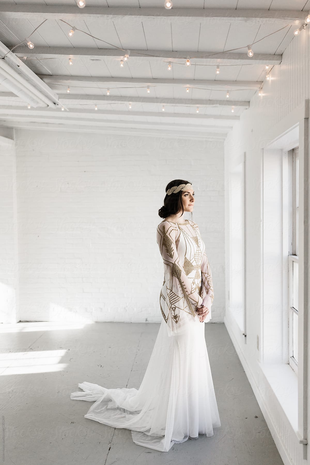 portrait of bohemian styled bride in white warehouse
