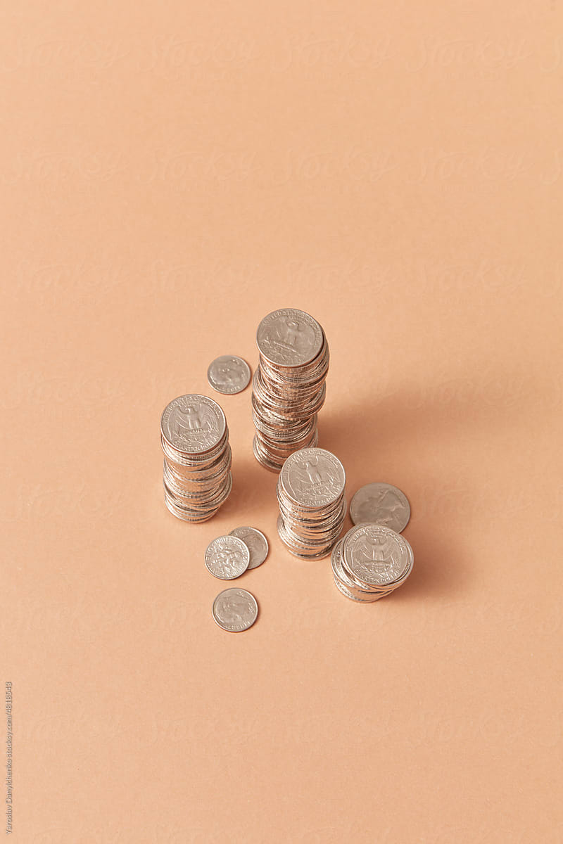 Stacks of cents on coral background.