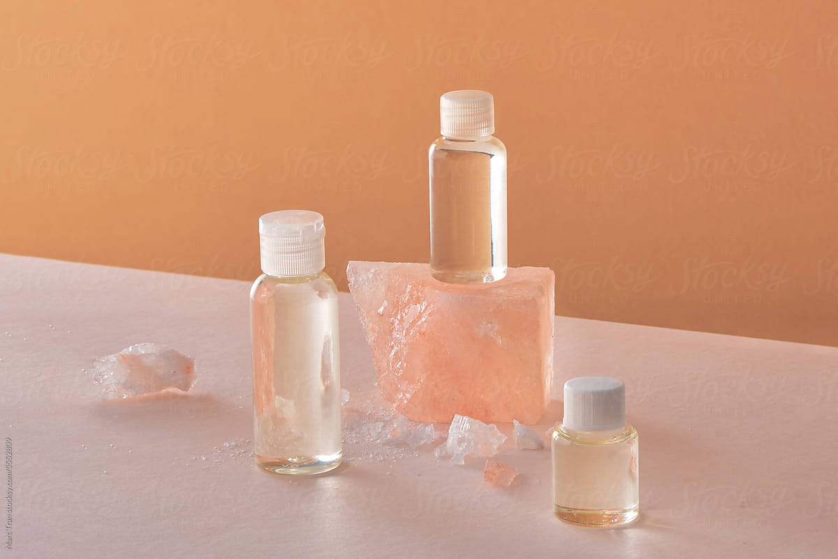 Bottles of essential oil with himalayan salt rocks