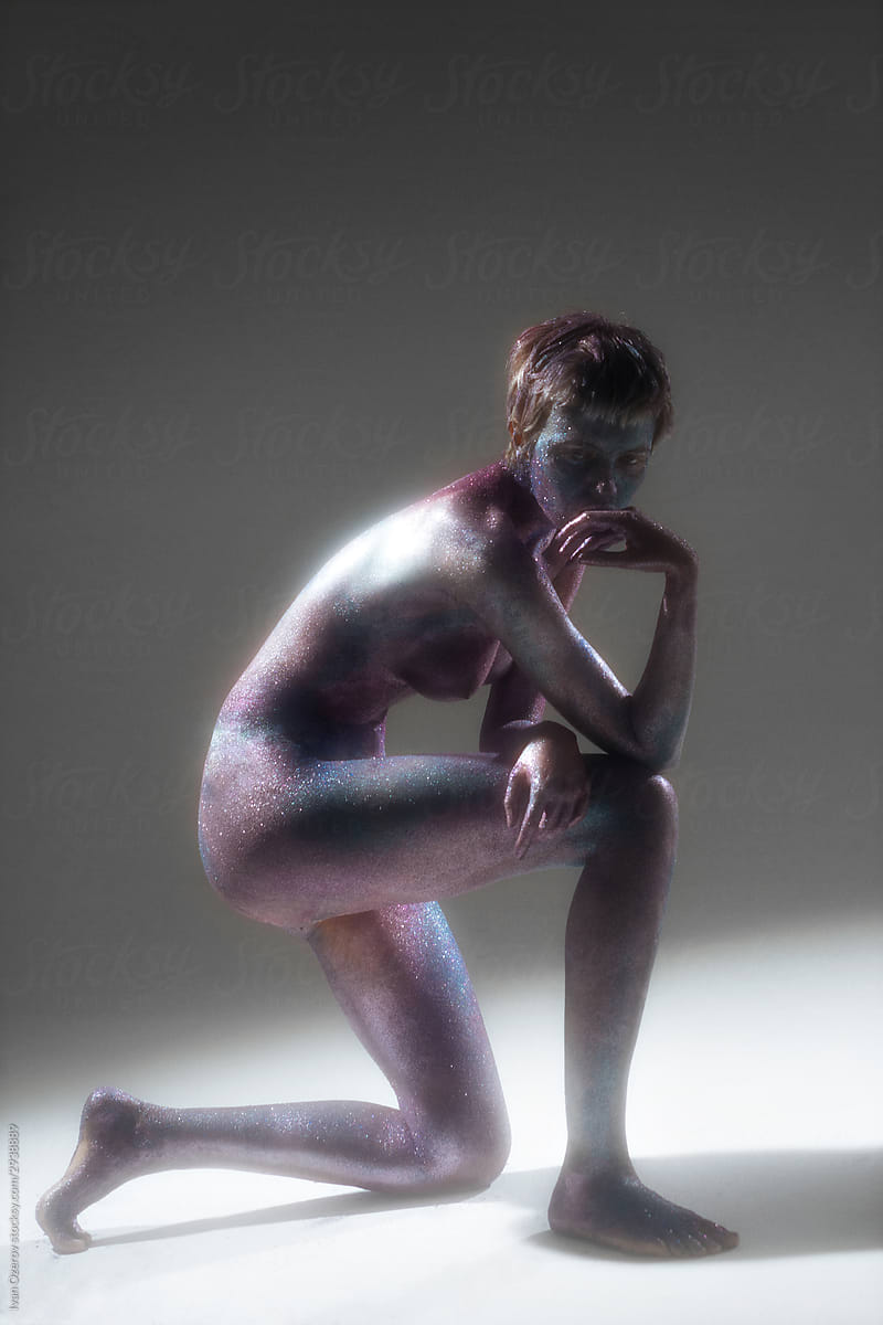 nude model with painted body in studio