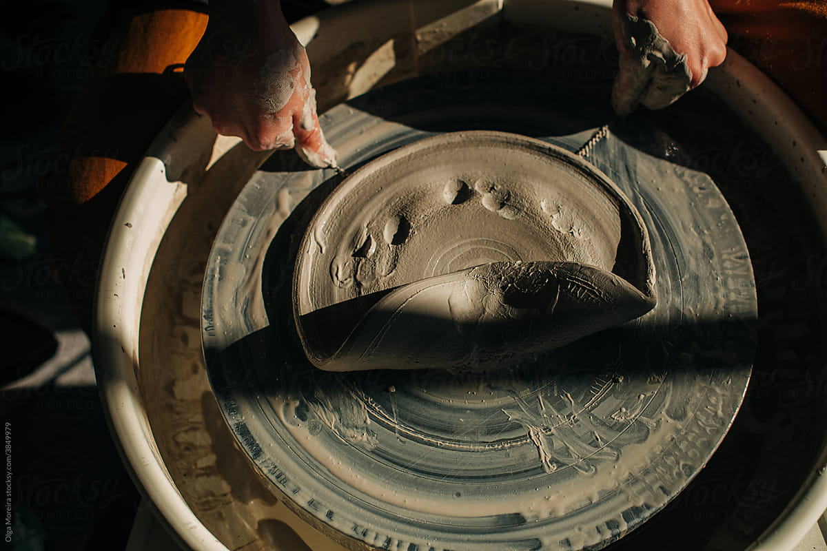 Potter taking clay from the pottery wheel