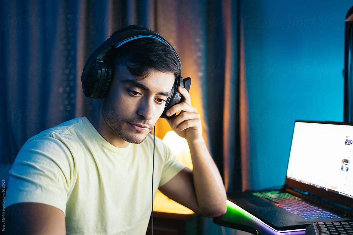 Young man playing video games online