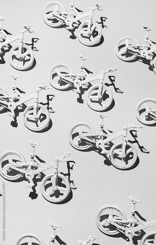 White bicycle miniatures on white background.