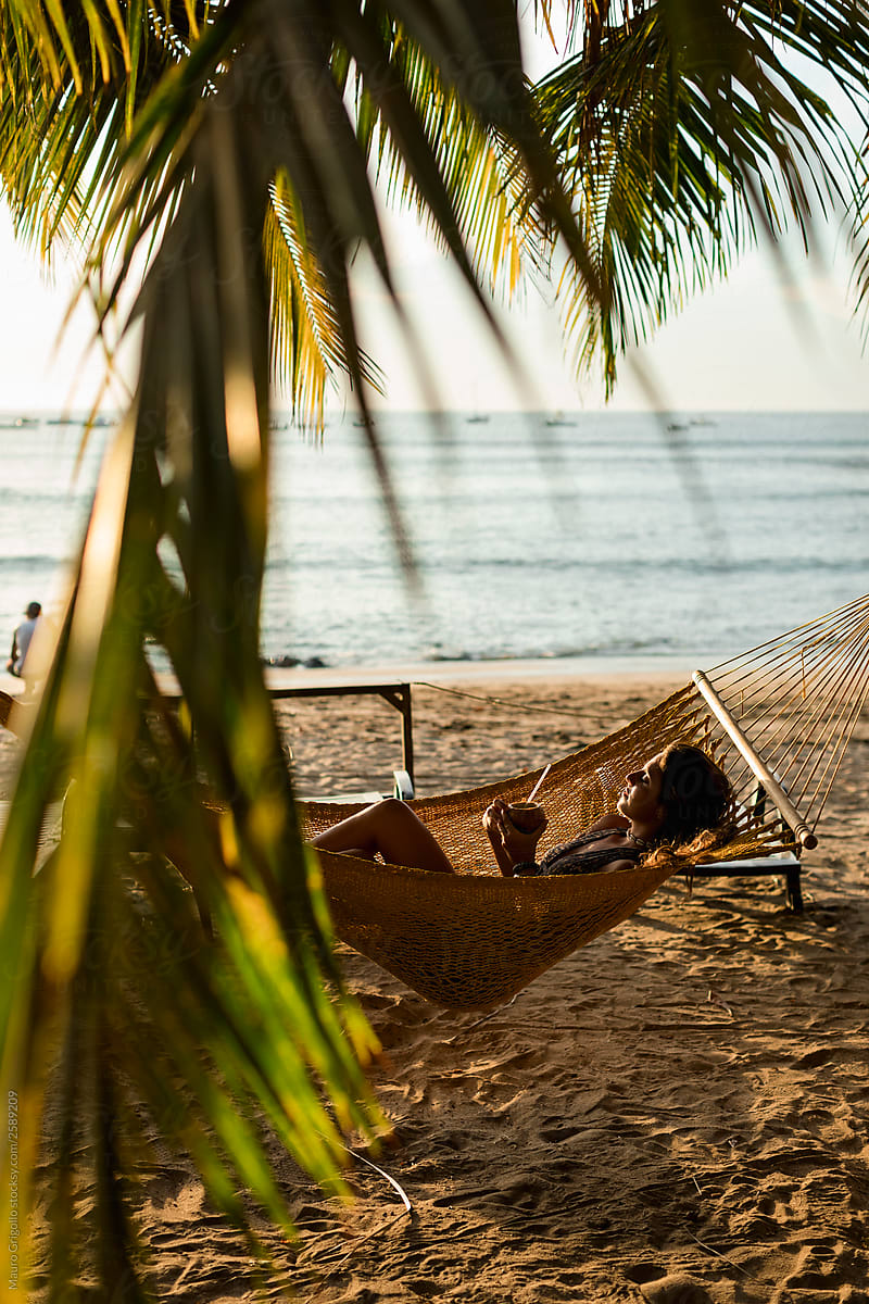 Girl relaxing on a hammock on the beach