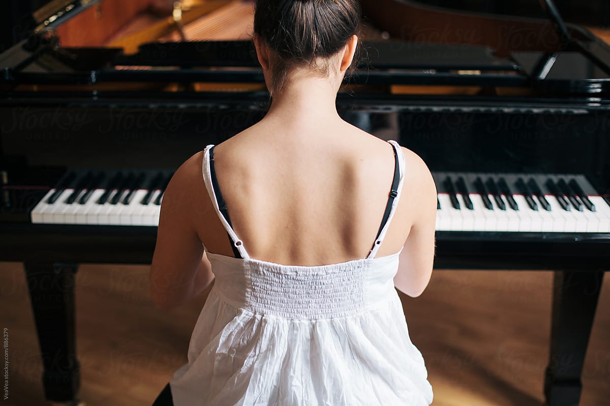 Woman playing piano indoor