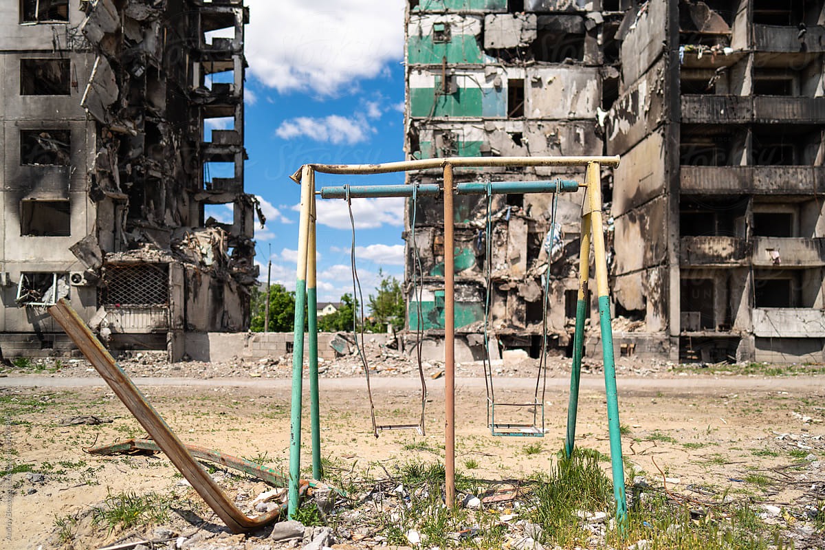 Children\'s swing against the background of the ruins.
