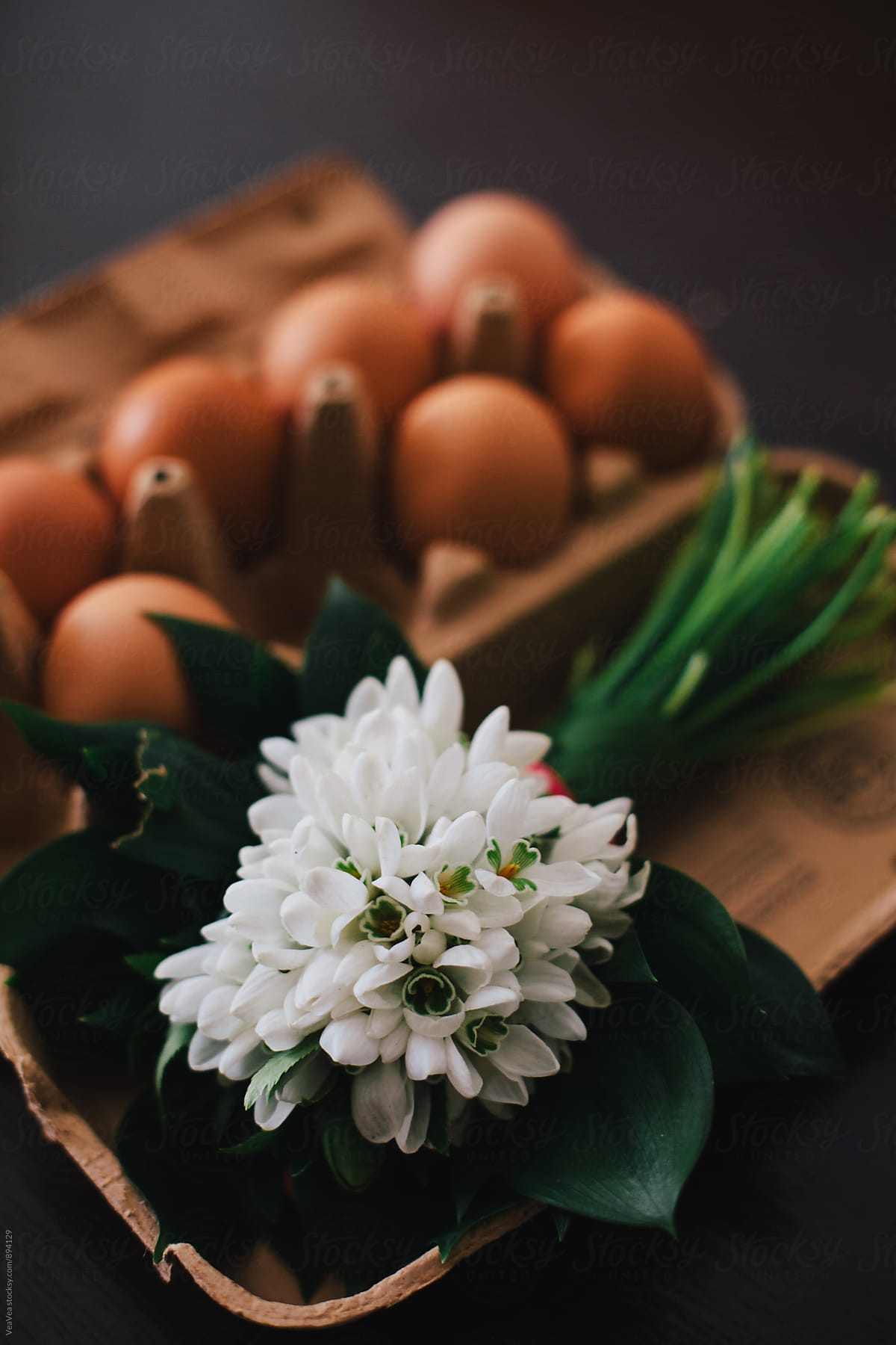 Bouquet of snowdrops and eggs on a table
