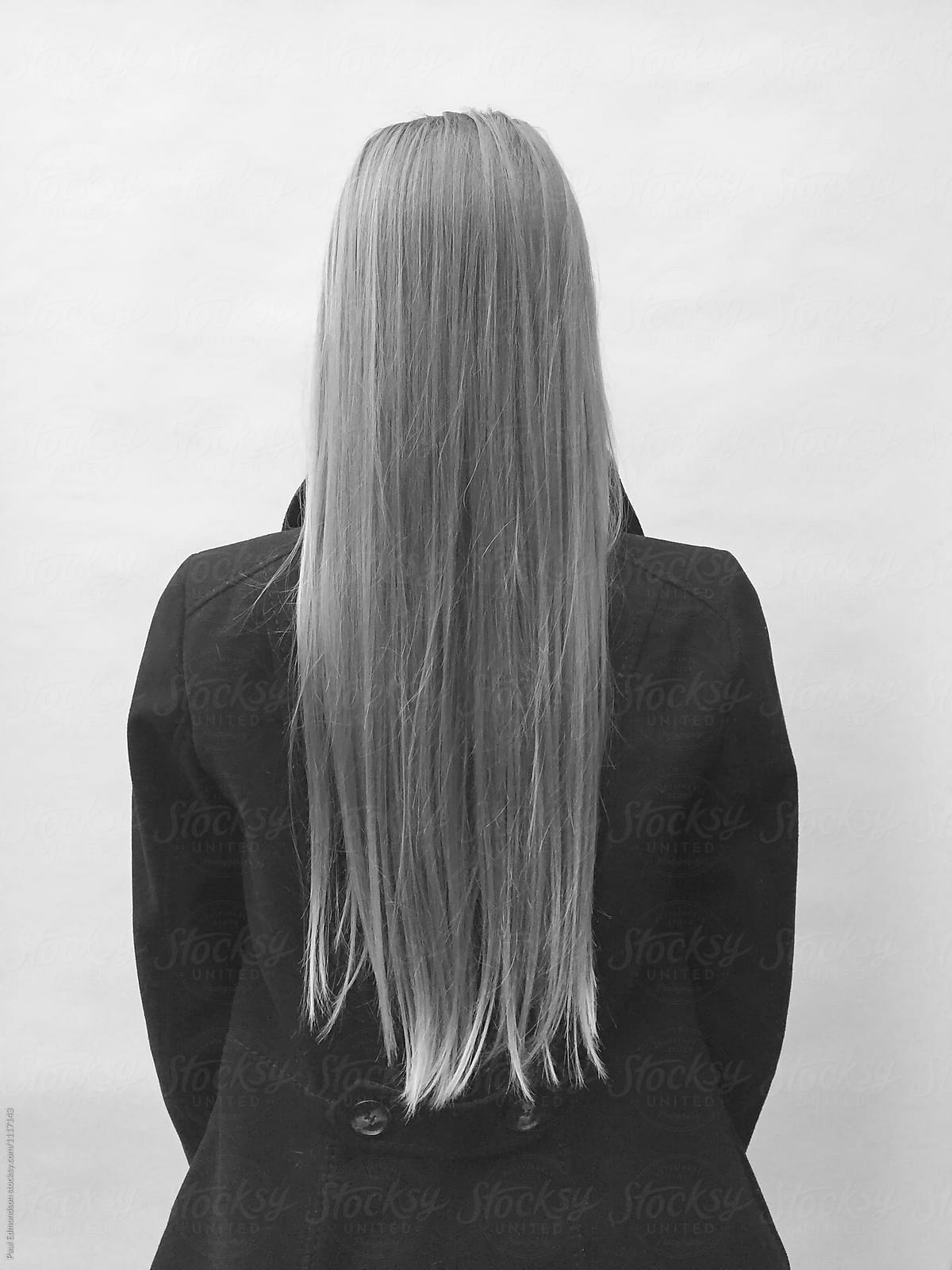 Teenage girl with long, straight hair, facing away