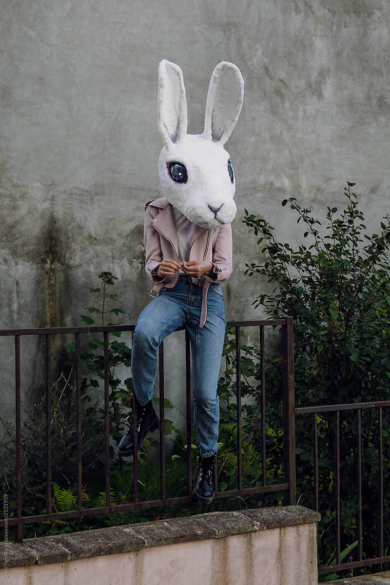 Stylish woman in white rabbit mask