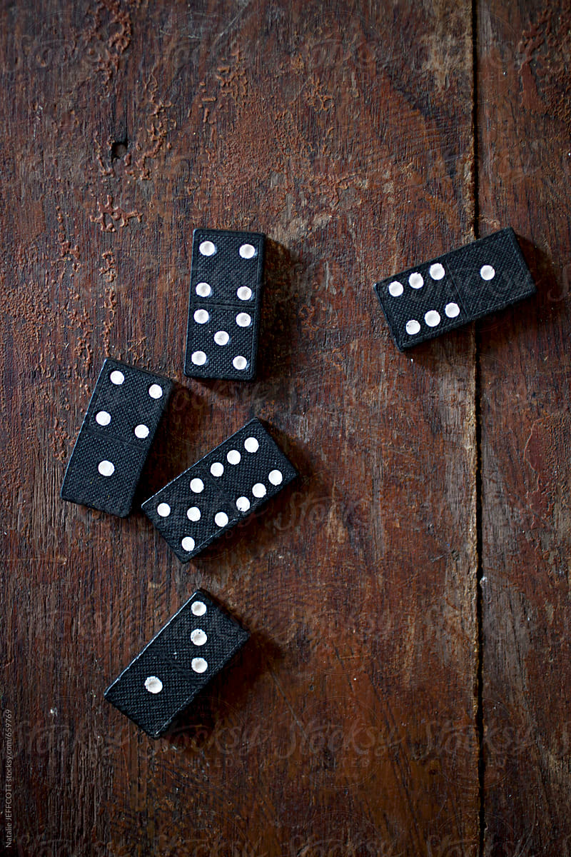 vintage black and white dominoes on a wooden table top
