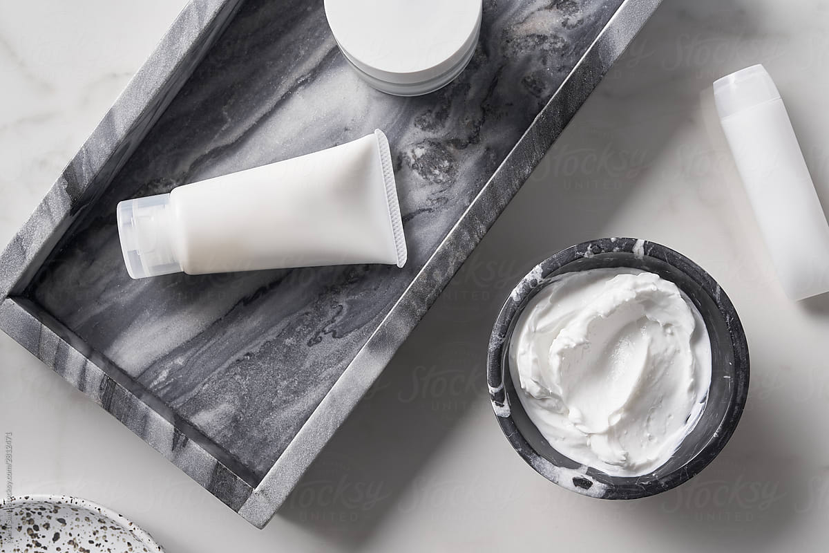 Skincare products near marble tray