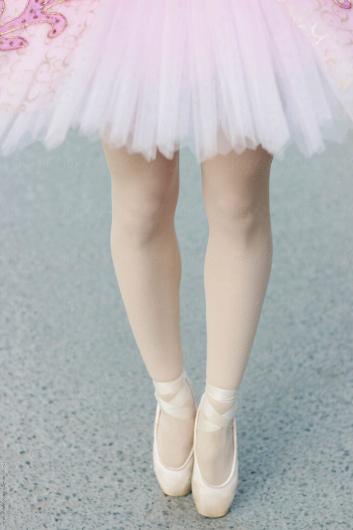 Female in romantic style ballet tutu and worn ballet shoes