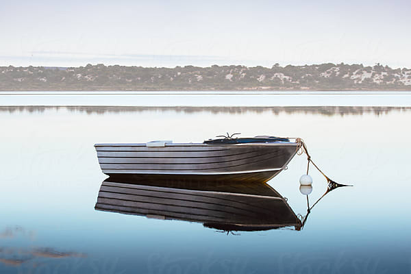 Small Boat On A Calm Cool Morning by Stocksy Contributor Robert