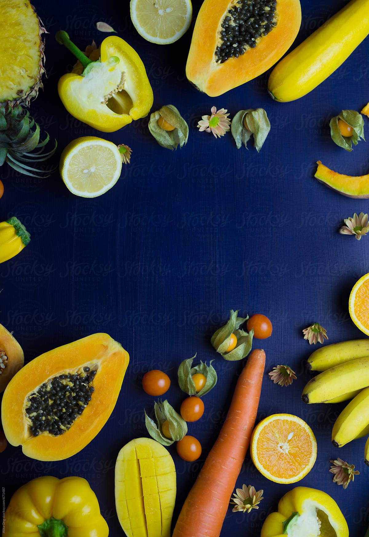 Yellow fruits and vegetables on dark blue