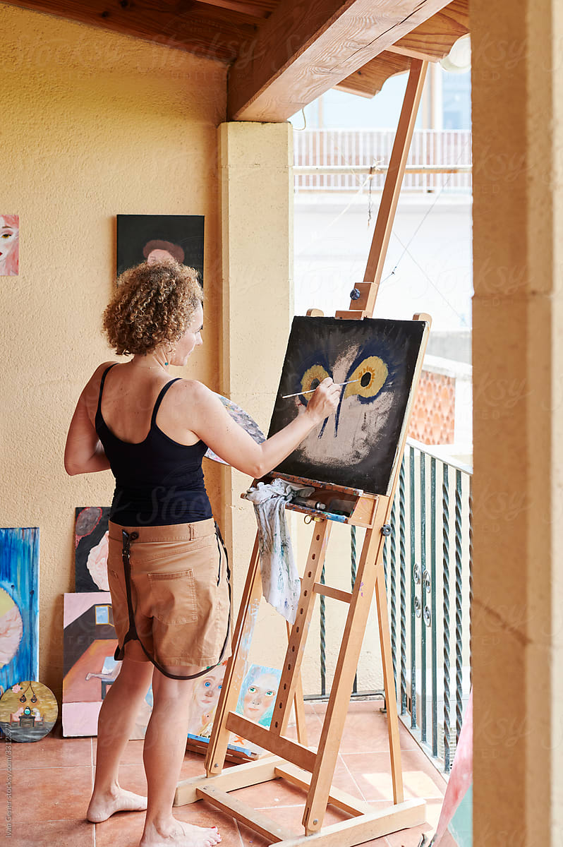 Mature woman painting in her art studio