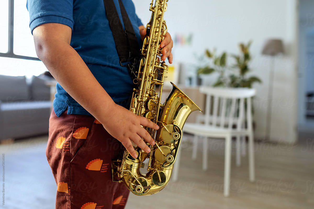 faceless kid Playing Saxophone at home