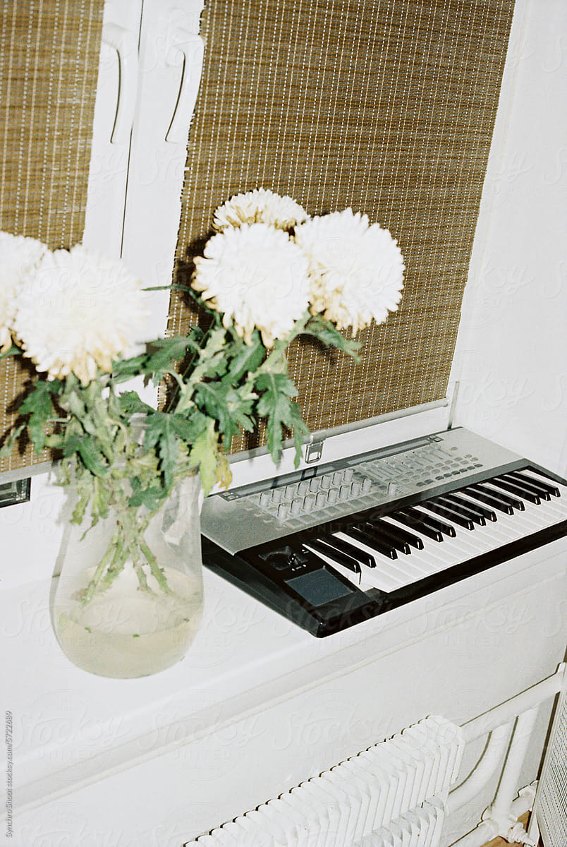 Bouquet of flowers and synthesizer indoors