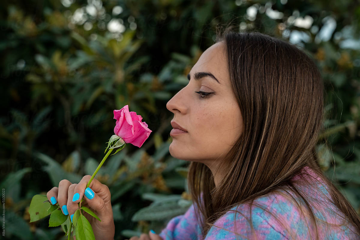Woman with rose portrait outdoors