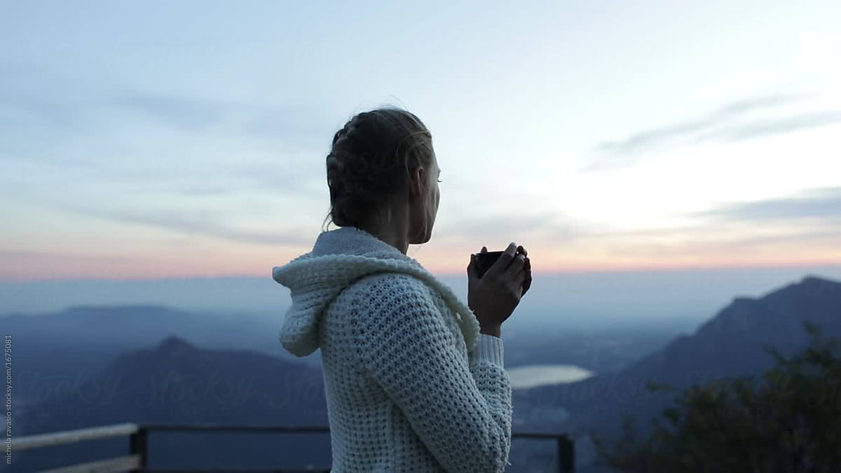 Girl Drinking A Cup Of Tea At Sunset In The Mountain By Stocksy