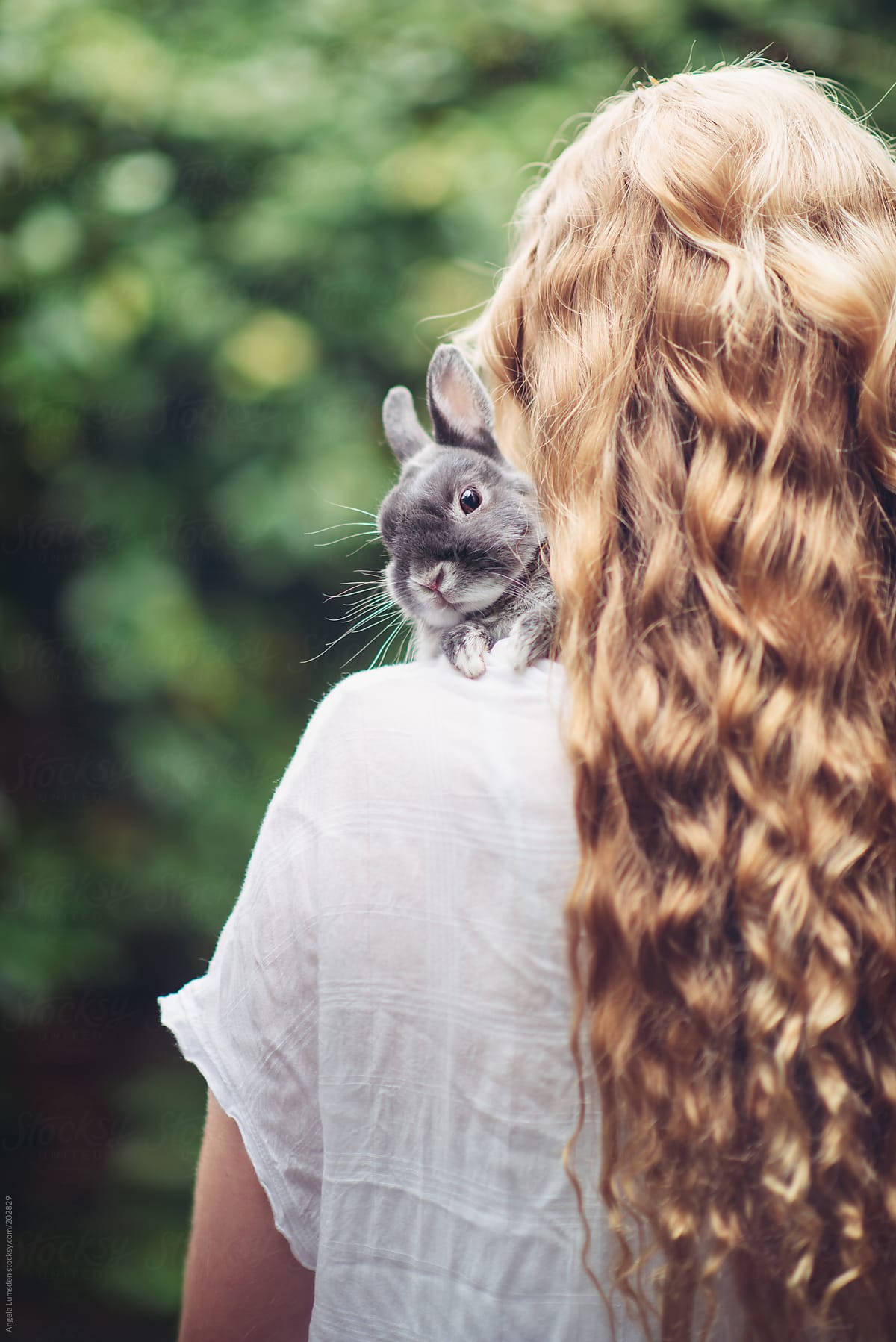 Teenage girl with a small grey rabbit