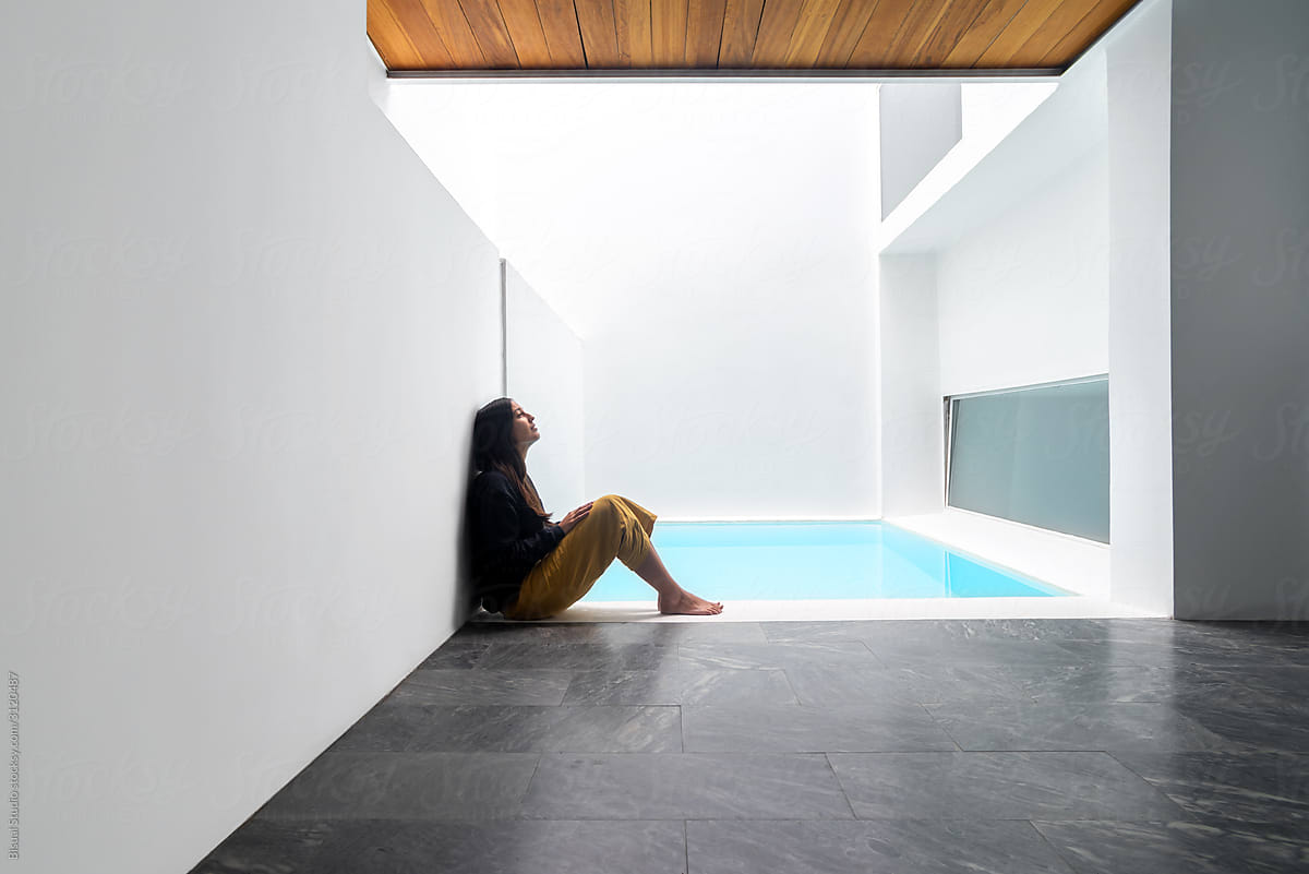 Woman on a luxury indoor pool in a modern house