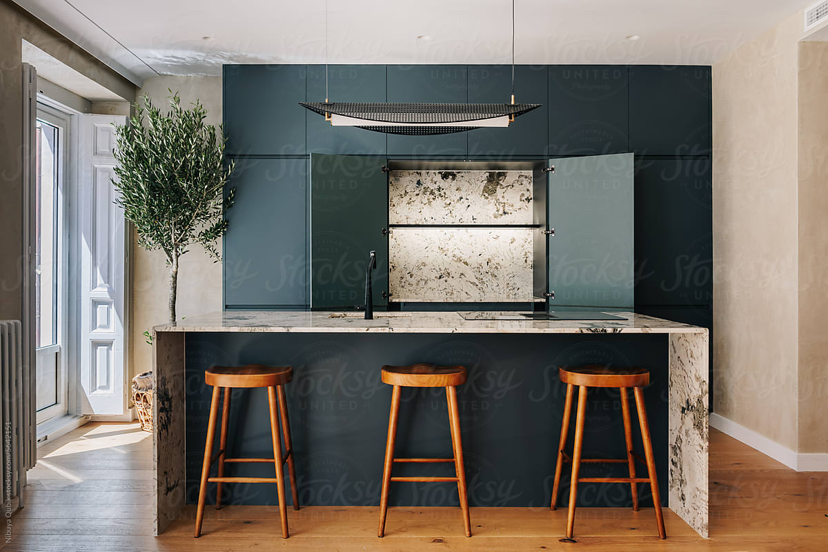 Modern Kitchen with dark green cabinetry and marble kitchen island