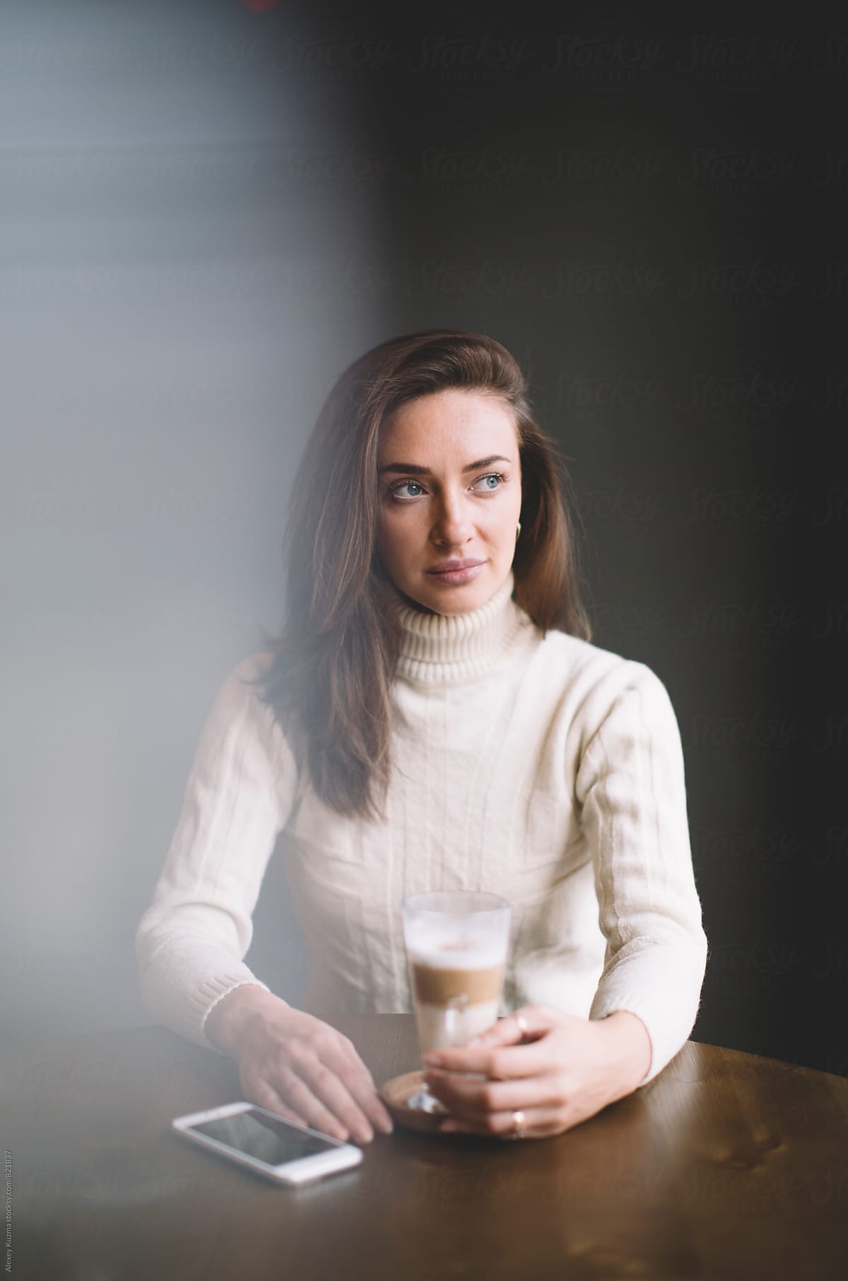 portrait of real woman sitting in a Coffee Shop.