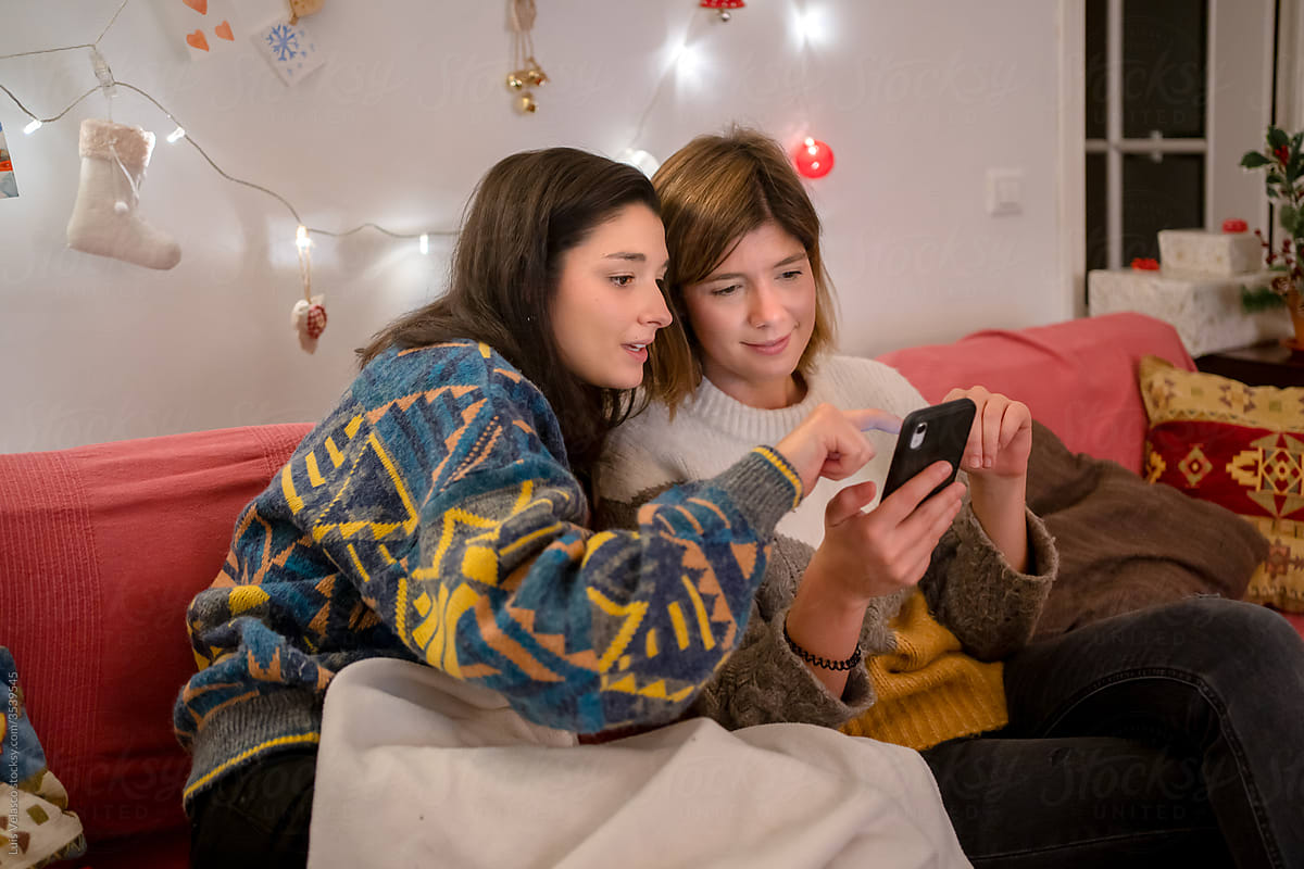 Girls On The Couch Having A Video Call In Christmas.
