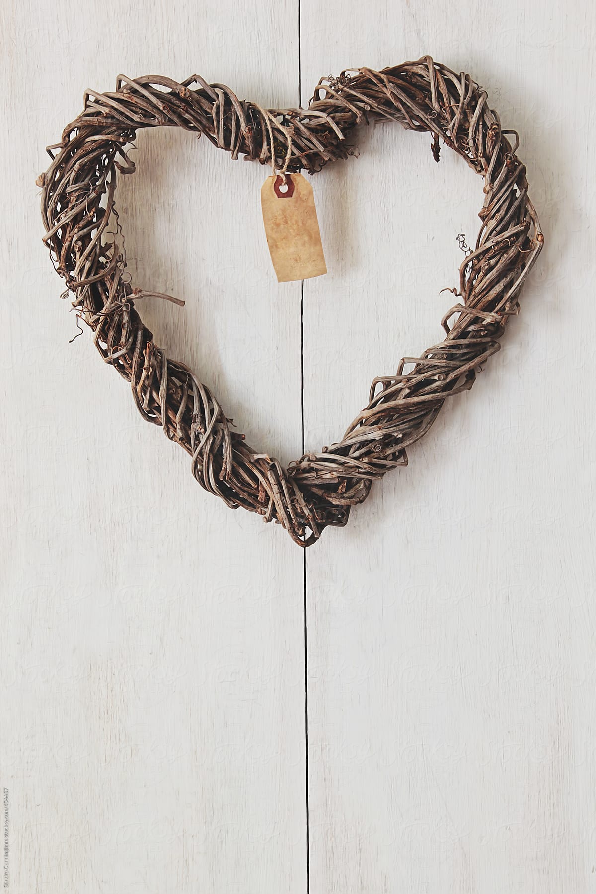 Heart wreath hanging on wood background