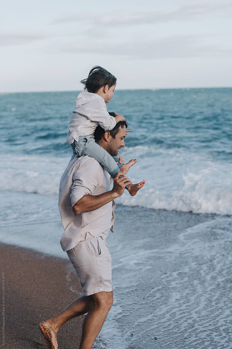 Little Boy On His Dad\'s Shoulders. Family Having  Fun Near Ocean
